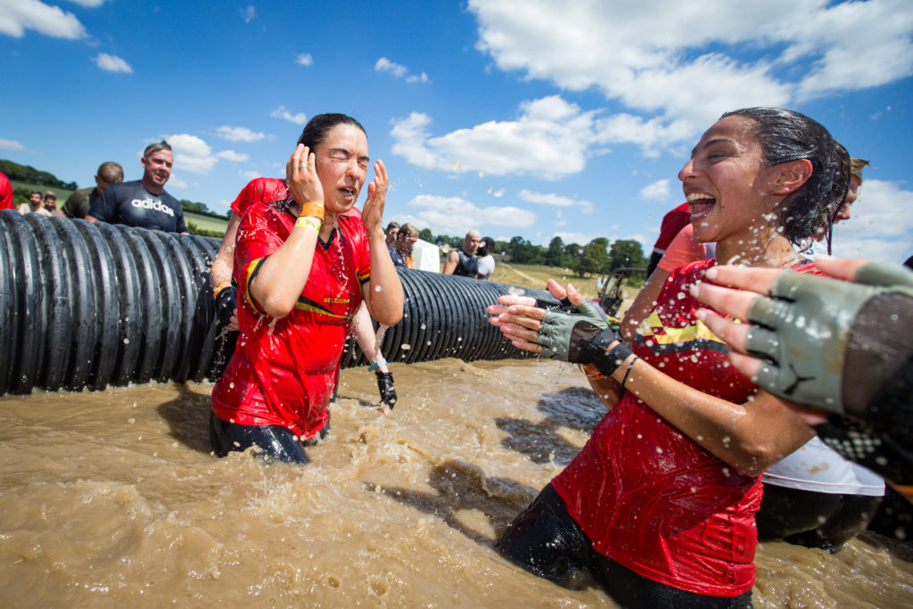 Two teammates clap as their friend emerges from water